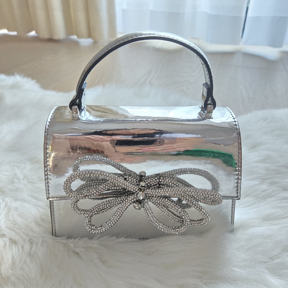 Silver Designer Handbag with Bow Accent